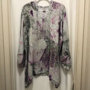 Long sleeve lighter weight hooded top with shark bite hem.